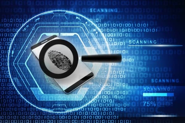 Magnifying glass over a fingerprint on a digital background.