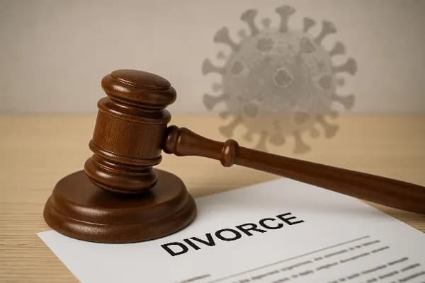 A gavel rests on top of a legal document, symbolizing the intersection of law and personal matters in divorce proceedings. The background features a subtle overlay of the COVID-19 virus illustration, representing the pandemic's impact on legal processes.