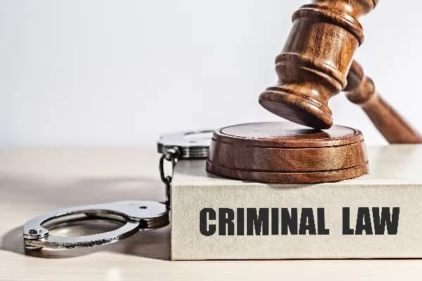 Image of a gavel and law book on a wooden desk, representing the topic of Oregon criminal law discussed in the blog post. What is Oregon criminal law?