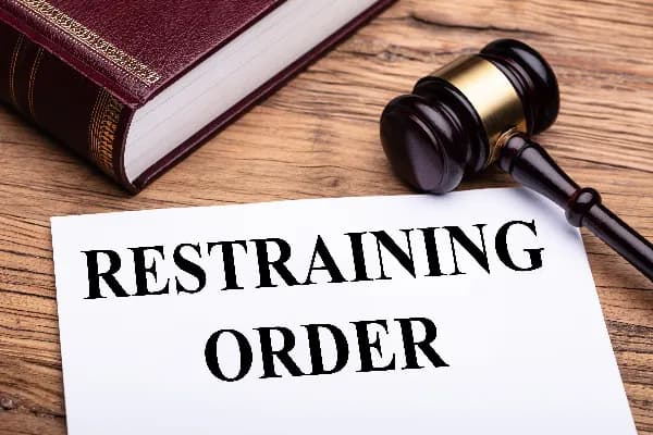 Image of a gavel and a piece of paper representing an Oregon restraining order. What is an Oregon Restraining Order?