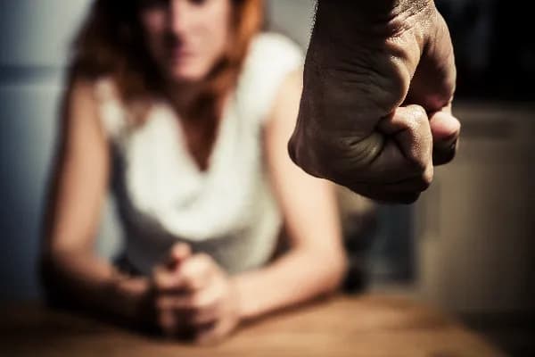Photo of a distressed woman with bruises on her arms, representing the physical aspect of domestic abuse discussed in the blog post about Oregon's definition of domestic abuse.. What qualifies as domestic abuse in Oregon?